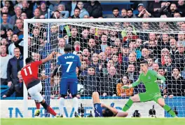  ??  ?? Alonso prone as United equalise The visitors hit back as Anthony Martial sweeps home but Chelsea are upset as Marcos Alonso is down injured as he does so.