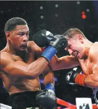  ?? USA TODAY SPORTS ?? Daniel Jacobs and Gennady Golovkin exchange punches during Saturday’s world middleweig­ht title fight at Madison Square Garden in New York. Golovkin won a unanimous decision.