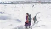  ?? WASEEM ANDRABI/HT ?? People walk on a snow-covered road in Shopian. n