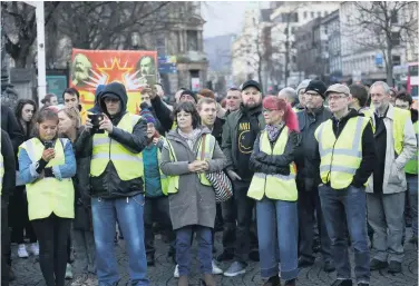  ??  ?? Yellow vest activists (also below) were among the protesters outside Belfast City Hall on Saturday