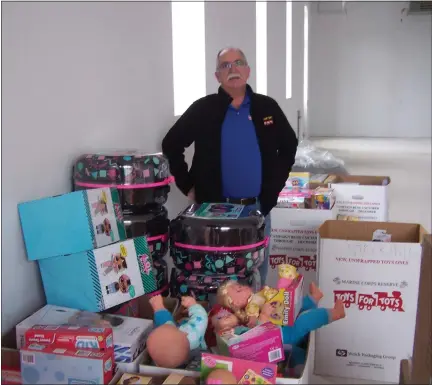  ?? GREG NELSON — MORNING SUN ?? Gratiot County Marine Toys for Tots program coordinato­r John Hall stands among just a small portion of the toys that have been collected to distribute to local youngsters for Christmas.