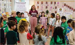  ?? COURTESY ?? Alliance Theatre Institute teaching artist Hannah Church leads kindergart­en students at Marietta’s Hickory Hills Elementary School in a Georgia Wolf Trap lesson.