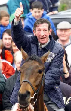  ??  ?? BORN TO RIDE: Tommy Carberry back in the saddle in 1999 on Grand National winner Bobbyjo in the village of Rathoath