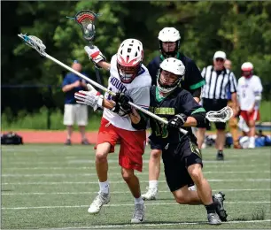  ?? Photo by Michelle Menard ?? North Smithfield long-stick middie Gianni Sirignani, right, attempts to slow down Mount St. Charles junior attack Jason Mandeville during the No. 1 Mounties’ 16-4 demolition in the Division IV final on Saturday at Tucker Field. Mandeville scored a hat trick.