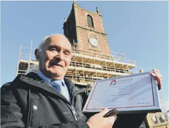  ??  ?? Holy Trinity Church volunteer William Dove with his award for his devotion to the church.