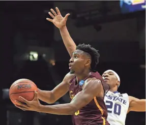  ?? BRETT DAVIS/USA TODAY SPORTS ?? Loyola guard Donte Ingram drives to the basket against Kansas State forward Xavier Sneed (20) during the second half Saturday.