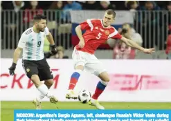  ??  ?? MOSCOW: Argentina’s Sergio Aguero, left, challenges Russia’s Viktor Vasin during their internatio­nal friendly soccer match between Russia and Argentina at Luzhniki stadium in Moscow. — AP