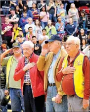  ?? Janelle Jessen/Siloam Sunday ?? Veterans saluted the American Flag as the colors were posted during the Veterans Day Program, held at Siloam Springs High School on Friday.