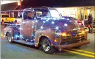  ?? Photo by Randy Moll ?? This antique truck donned special Christmas lights in the annual Gentry Chamber of Commerce Christmas Parade on Saturday.