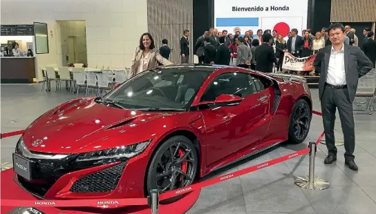  ?? ROB MAETZIG/STUFF ?? Honda NZ managing director Nobuya Sonoda and general manager of marketing Nadine Bell pose with a Honda NSX at the company’s Honda HQ.