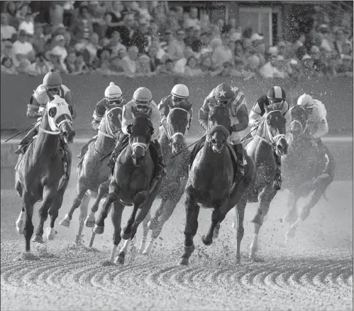  ?? Arkansas Democrat-Gazette/MELISSA SUE GERRITS ?? Bayern Bayern (center), (center), with with jockey jockey Gary Gary Stevens Stevens aboard, aboard, leads eventual winner Danza (second from right) and the rest of the field around the first turn during the Arkansas Derby on Saturday at Oaklawn Park....