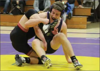  ?? MIKE BUSH/NEWS-SENTINEL ?? Tokay wrestler Carson Ward puts the wraps on Lincoln's Cole Jackson in the 145-pound match of Thursday's TCAL wrestling match at The Jungle.