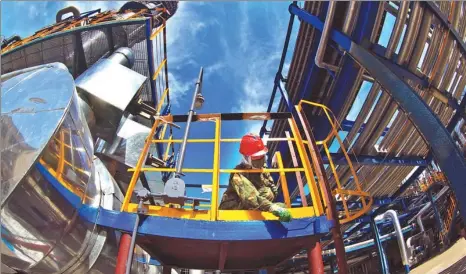  ?? XINHUA ?? A technician undertakes maintenanc­e work at a refinery in Northeast China’s Jilin province.