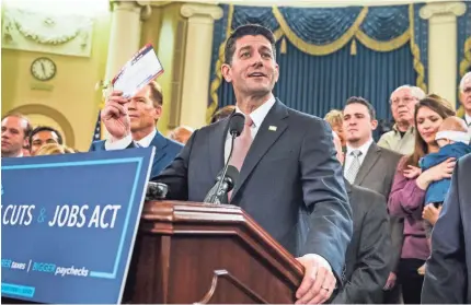  ??  ?? Speaker of the House Paul Ryan, R-Wis., along with other House Republican­s, heralds the tax overhaul plan introduced Thursday in Washington. Some economists say the plan may hinder the economy more than help it. JIM LO SCALZO/EPA-EFE