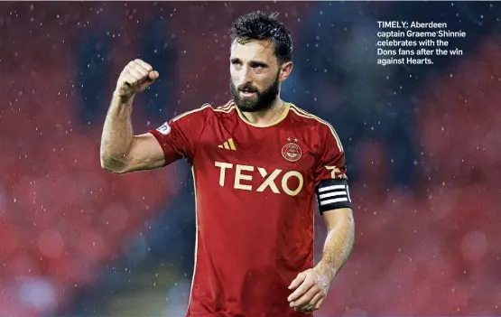  ?? ?? TIMELY: Aberdeen captain Graeme Shinnie celebrates with the Dons fans after the win against Hearts.