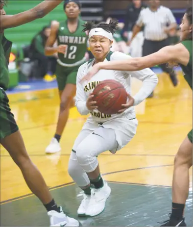  ?? Erik Trautmann / Hearst Connecticu­t Media ?? Trinity Catholic’s Caitlyn Scott goes to the hoop against Norwalk on Thursday night in Stamford.