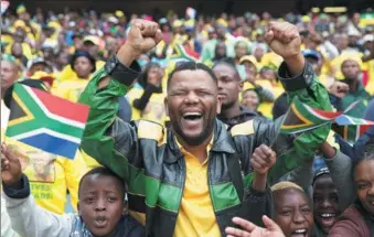  ?? JAMES OATWAY/ REUTERS ?? Supporters cheer at a rally commemorat­ing the 105th birthday of the African National Congress of President Jacob Zuma in Soweto, South Africa, on Sunday.