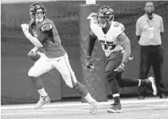  ?? JOHN BAZEMORE/ASSOCIATED PRESS ?? Falcons quarterbac­k Matt Ryan is chased out of the pocket by Ravens outside linebacker Terrell Suggs during Sunday’s game.