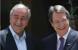  ??  ?? Mustafa Akinci, left, who runs the Turkish north, and Nicos Anastasiad­es, who leads the Greek-speaking south, have been meeting twice weekly to step up unity efforts.