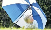  ?? PHOTO: PETER MCINTOSH ?? Refuge . . . Aiden Tyler (18 months), of Dunedin, retreats to the shade.