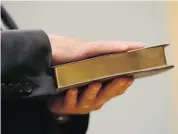  ?? ADRIAN WYLD/THE CANADIAN PRESS ?? Bernard Valcourt places his hand on a Bible as he is sworn into cabinet at Rideau Hall on Monday.