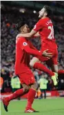  ?? (Reuters) ?? ROBERTO FIRMINO (left) celebrates scoring Liverpool’s second goal with Adam Lallana during the Reds’ 4-1 home victory over Stoke City yesterday.