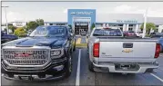  ?? STEVE HELBER / AP ?? Trucks are lined up in front of a Chevrolet dealership in Richmond, Va., recently. On Friday, the Commerce Department released its July report on durable goods, a closely watched economic indicator.