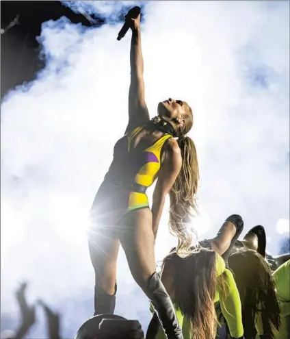  ?? Photograph­s by Jason Armond Los Angeles Times ?? SHE’S BACK: Jennifer Lopez pauses mid-performanc­e Sunday evening during “Vax Live” at new SoFi Stadium in Inglewood.