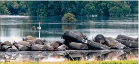  ?? TIM HYNDS / SIOUX CITY JOURNAL ?? Tank cars carrying crude oil derailed about a mile south of Doon, Iowa on Friday morning, possibly due to floodwater­s from the swollen Little Rock River.