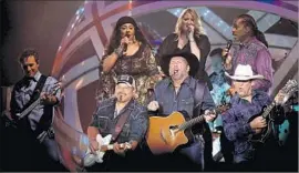  ?? Luis Sinco Los Angeles Times ?? GARTH BROOKS is the focal point as he performs with the help of his band and backing singers at the Forum on Saturday night, a show that lasted three hours.