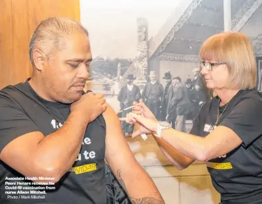  ?? Photo / Mark Mitchell ?? Associate Health Minister Peeni Henare receives his Covid-19 vaccinatio­n from nurse Alison Mitchell.