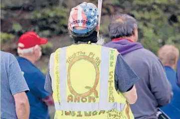  ?? TED S. WARREN/AP 2020 ?? President Joe Biden’s inaugurati­on has sown a mixture of anger, confusion and disappoint­ment among believers in the QAnon conspiracy theory. Above, a person wears a vest supporting QAnon at a rally in Olympia, Washington.
