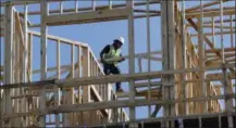  ?? MARK HUMPHREY — THE ASSOCIATED PRESS ?? Workers build an apartment and retail complex in Nashville, Tenn. On Friday the Commerce Department issues the first estimate of how the U.S. economy performed in the October-December quarter.