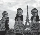  ?? DIMITAR DILKOFF/AFP VIA GETTY IMAGES ?? Activists with masks depicting French President Emmanuel Macron hold placards Friday during a rally in support of victims of sexual assault in Paris.