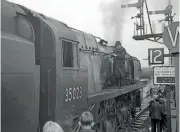  ?? JOHN TILEY ?? No. 35023 Holland-Afrika Line waits at Salisbury after its 100mph run from Waterloo on October 15, 1966. Inspector Arthur Jupp is standing on the running plate.