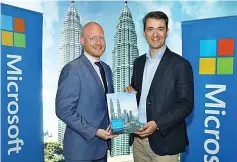  ??  ?? Britton (left) with Giron at the launch of study titled ‘Ensuring Agility And Trust In A Rapidly Changing Business Environmen­t’ at Kuala Lumpur. FSIs across the Asia Pacific region are under pressure to increase agility, improve efficiency, and embrace...