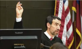  ?? ALYSSA POINTER PHOTOS / ALYSSA.POINTER@AJC.COM ?? Fulton County Chief Judge Robert McBurney raises his hand Monday to repeat an oath for the possible jury to repeat during the first day of jury selection for the Tex McIver case. McIver is accused of fatally shooting his wife.