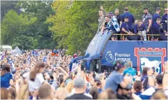  ?? REUTERS ?? Ipswich Town manager Kieran McKenna and players wave to the fans from the parade bus as they celebrate promotion to Premier League.