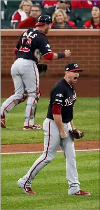  ?? CHARLIE RIEDEL — THE ASSOCIATED PRESS ?? Washington’s Daniel Hudson and Yan Gomes celebrate after Game 2 of the National League Championsh­ip Series against the St. Louis Cardinals Saturday in St. Louis. The Nationals won 3-1 to take a 2-0 lead in the series.