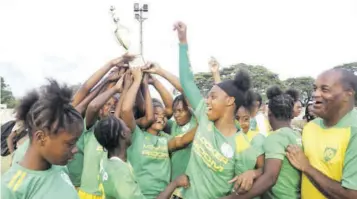  ?? (Photo: Dwayne Richards) ?? Excelsior Eagles celebrate their third-straight Issa/locker Room Sports/tip Friendly Society Schoolgirl Football title, after a 4-1 come-from-behind win over Denham Town High at Spanish Town Prison Oval last Friday.