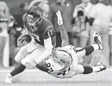  ?? ERIC GAY / AP ?? Texans quarterbac­k Brock Osweiler scrambles for a first down against Raiders defensive end Mario Edwards during an AFC Wild Card game Saturday in Houston.