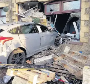  ??  ?? A family managed to escape unhurt after a Ford Focus was left embedded in the front of their house on Ewenny Road, Maesteg