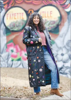  ?? (NWA Democrat-Gazette/David Gottschalk) ?? Designer Brandy Lee displays an upcycled leather coat featuring leather cutouts, rhinestone and leather flowers Tuesday outside her studio in Fayettevil­le. The Arkansas Arts and Fashion Forum said the pandemic has caused the need for changing how the industry operates, to include creating more of a reliance on American-made products and processes that will prevent lags in the industry in the future. Lee is creating a collection of jackets that she will be releasing after the first of the year. Go to nwaonline.com/210104Dail­y/ to see more photos.