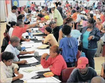  ?? PHOTO: SAM CLARK ?? Mitchells Plain residents line up for social grant registrati­on. South Africa has 16 million people receiving welfare and the writer argues that it is not sustainabl­e for our “developmen­tal state” to emulate rich countries when it comes to welfare...