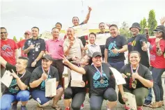  ??  ?? STRONGEST WOMAN ... Joyce (centre, back) gestures as she celebrates her victory with fellow winners and invited guests at the inaugural Sabah Strongest Woman Open Challenge in Donggongon near here yesterday.