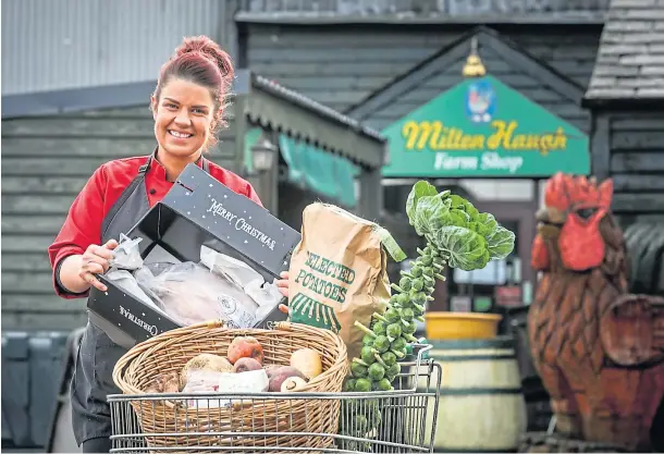  ??  ?? ONE-STOP SHOP: Corn Kist and Milton Haugh Farm Shop proprietor Elizabeth Gray with a turkey and all the trimmings. Picture by Mhairi Edwards.