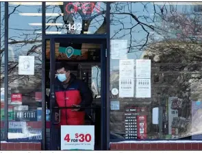  ?? (AP/Nam Y. Huh) ?? A customer exits a GameStop store in Vernon Hills, Ill., on Thursday, the day online trading platform Robinhood restricted trading in GameStop and other stocks that have soared recently because of purchases made by thousands of small investors.