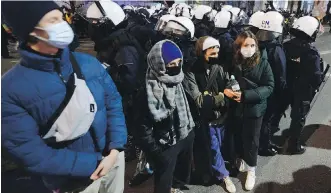  ?? THE ASSOCIATED PRESS ?? People demonstrat­e against police violence and an attempted restrictio­n on abortion rights, in Warsaw on Saturday.