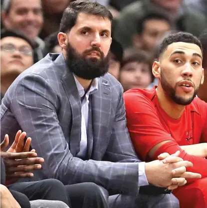  ?? | GETTY IMAGES ?? Bulls forward Nikola Mirotic sits on the bench next to Denzel Valentine during the game Tuesday against the Suns.