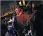  ?? PHOTO: REUTERS ?? Police officers detain a man for breaking curfew that was imposed after the death of Walter Wallace jun, a black man who was shot by police, in Philadelph­ia, Pennsylvan­ia, yesterday.